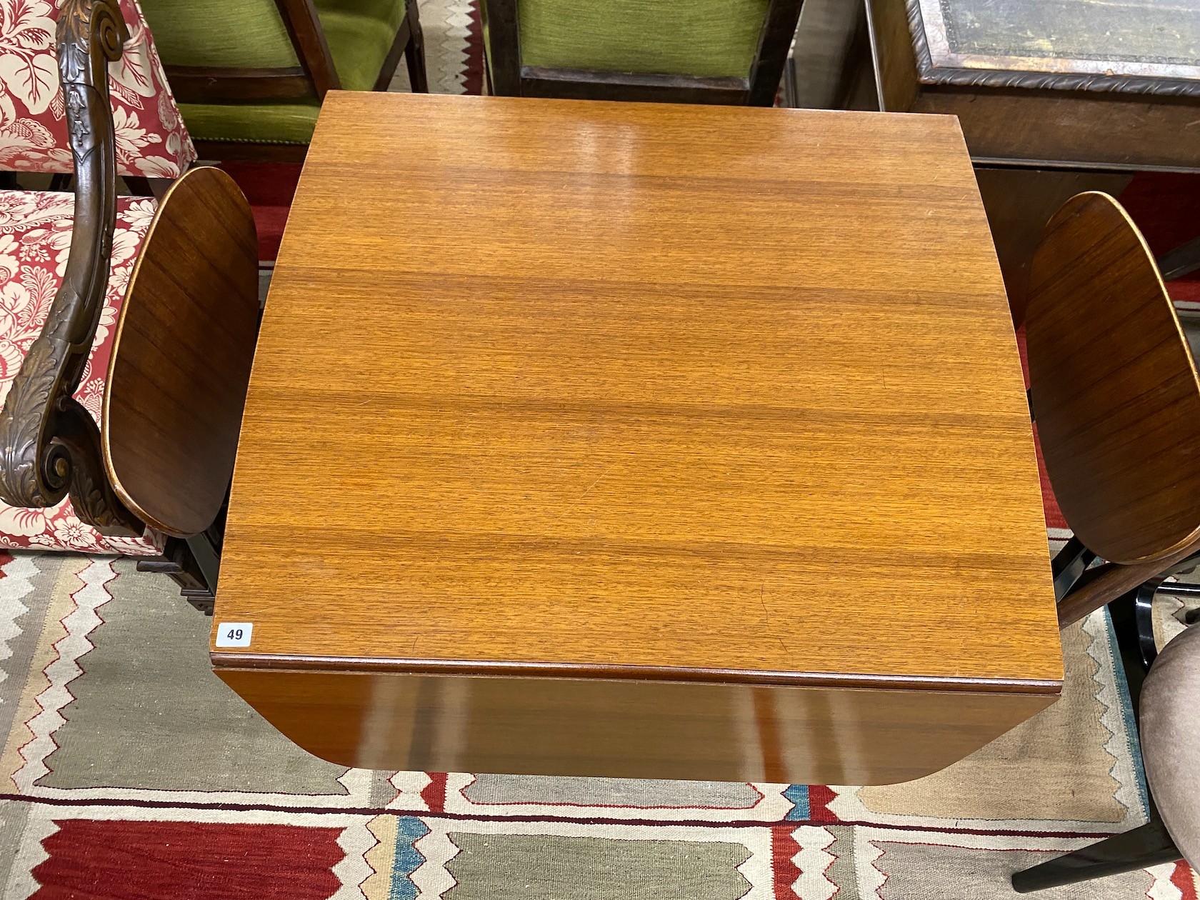 A 1950's G-plan table, approx. 150cm extended, width 82cm, height 72cm and four chairs